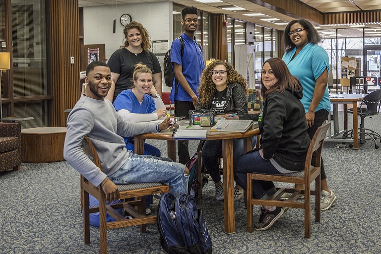students at a table in a library