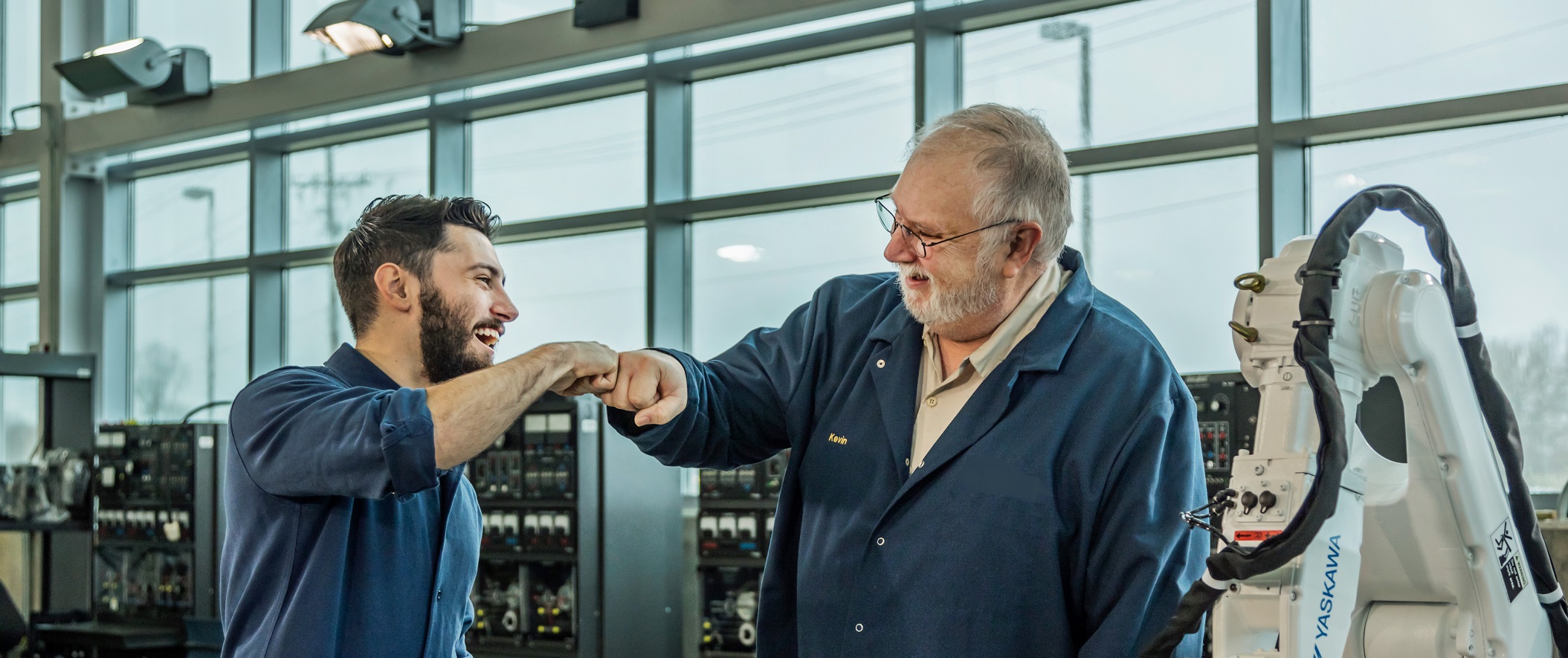 teacher fist bumping student