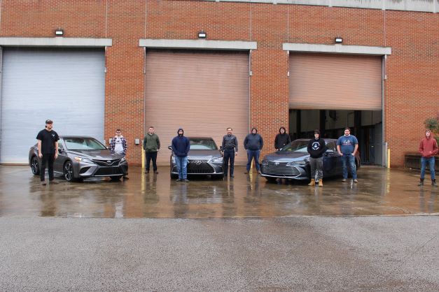 Southeast automotive technology students from Harlan County High School pose with the Camry, Lexus, and Avalon recently gifted by Toyota Manufacturing of Kentucky.