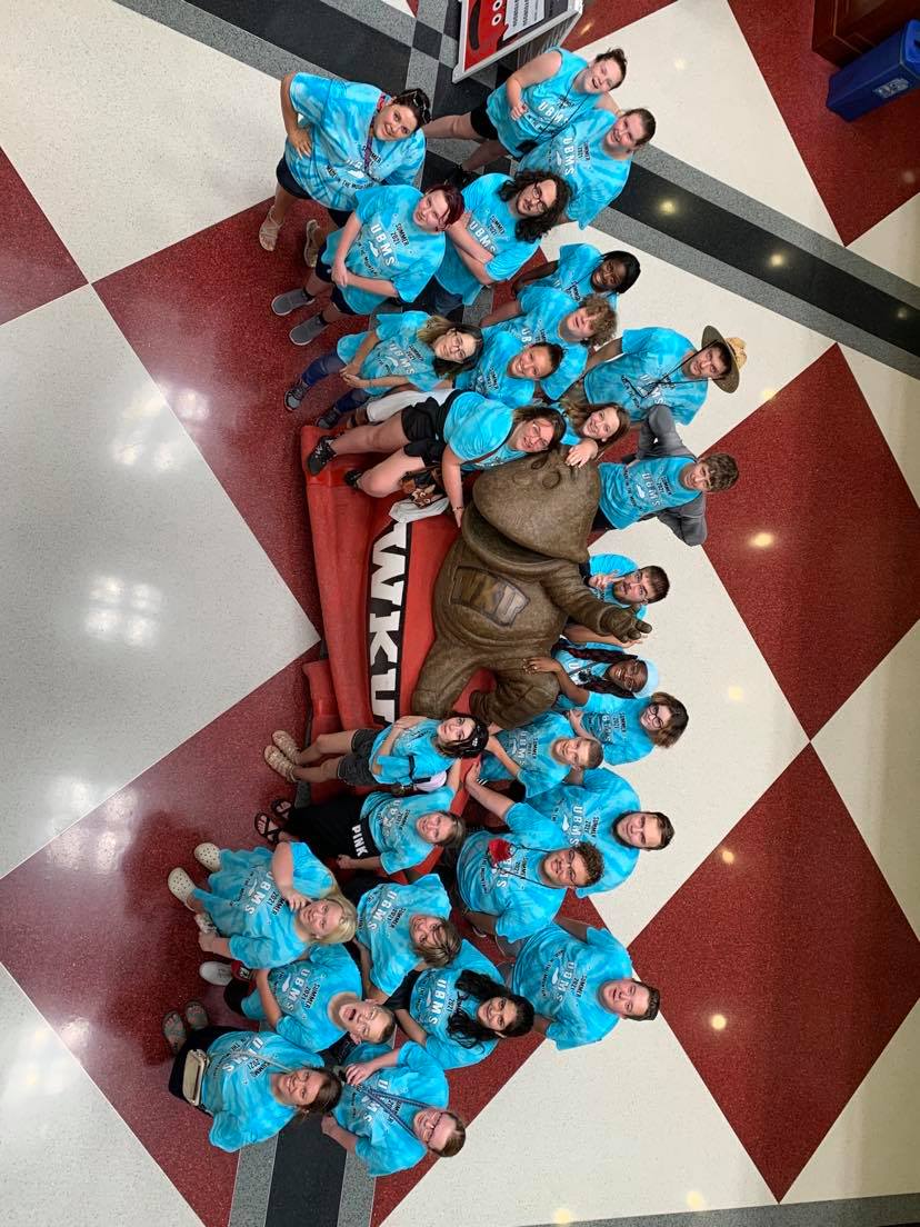 An overhead photo of students holding a WKU sign.