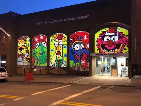 A muppet scene at a library with several different windows.