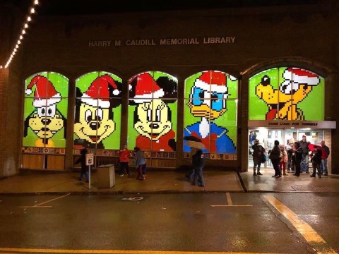 A Mickey Mouse Christmas scene at a library with multiple large windows.