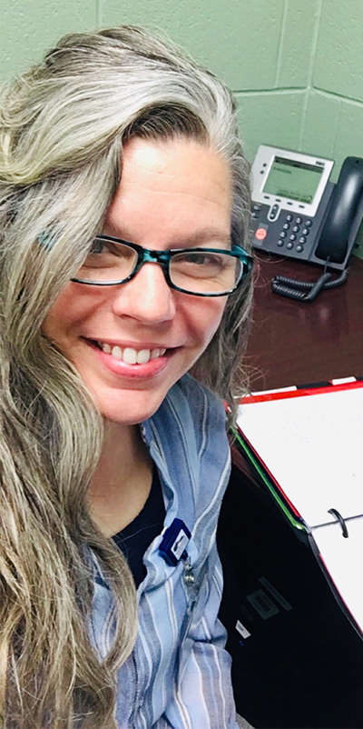 Michele Rapier doing school work at an office desk.