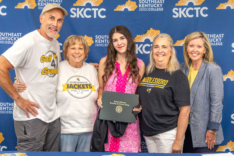 Aubrey Bailey Hatfield (center) receives the Middlesboro Alumni & Friends Association Scholarship during Southeast Kentucky Community & Technical College's Scholarship Signing Day. Joining Hatfield are Middlesboro Alumni & Friends Association representatives Scott Ballard, Cathy Brock, and Lisa Schneider, along with Rian Johnson, dean of advancement and public relations at SKCTC.