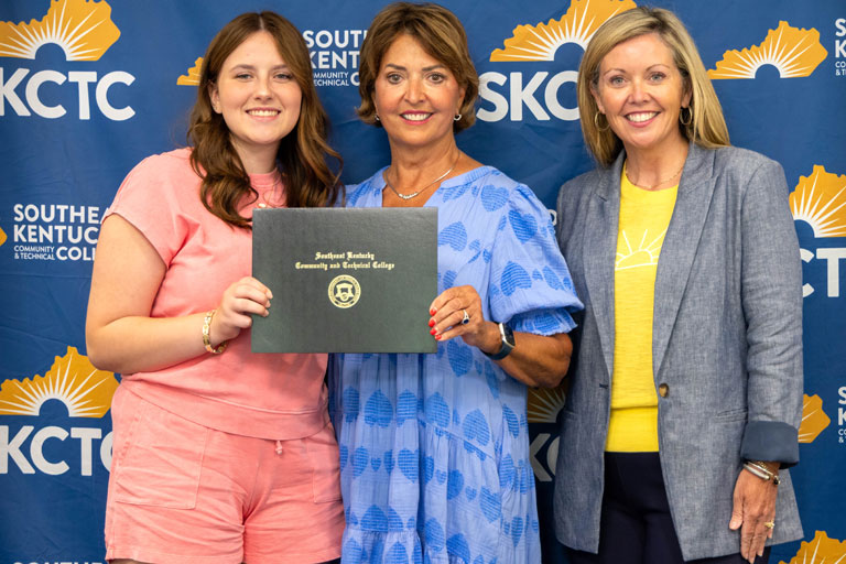 Emily Rose (left) receives the Mike Bowling Memorial Scholarship during Southeast Kentucky Community & Technical College's Scholarship Signing Day. Joining Rose are Jamie Bowling, widow of Mike Bowling, and Rian Johnson, dean of advancement and public relations at SKCTC.