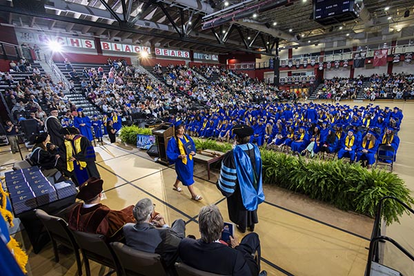 Graduates waiting to walk across the stage to get diploma